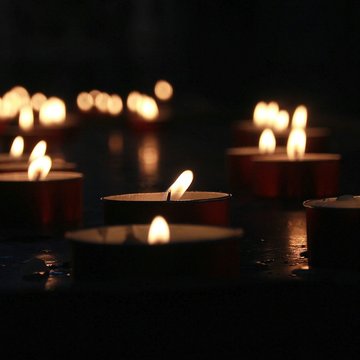 Brennende Teelichter im Dunkeln