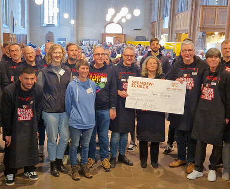 Ein Gruppenfoto mit Gabriele Ehrmann, ehrenamtlichen Helfern der Vesperkirche, Joachim Löw und Akteuren des VfB-Stuttgart, die einen Spendenscheck in der Hand halten.