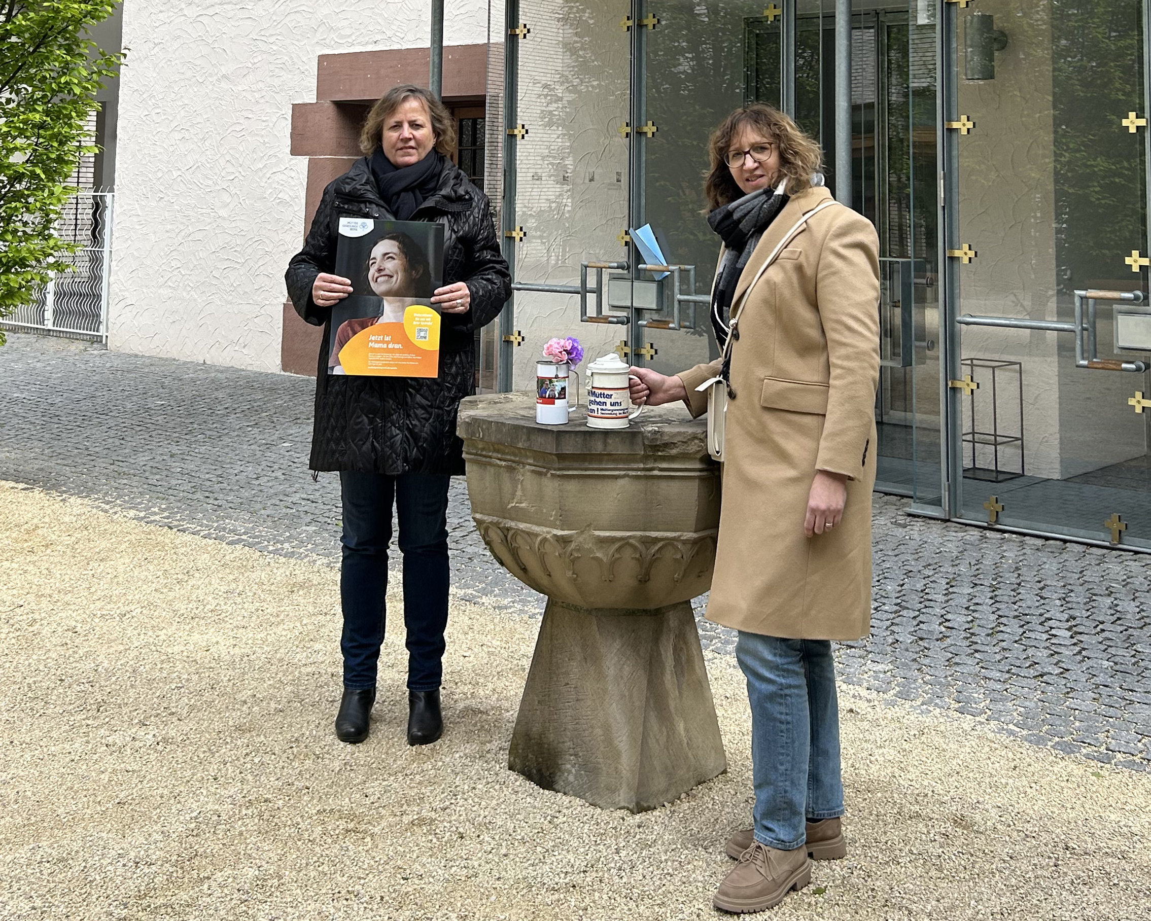 Zwei Frauen stehen vor einer Kirche
