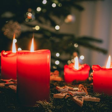 Vier angezündete rote Kerzen am Adventskranz