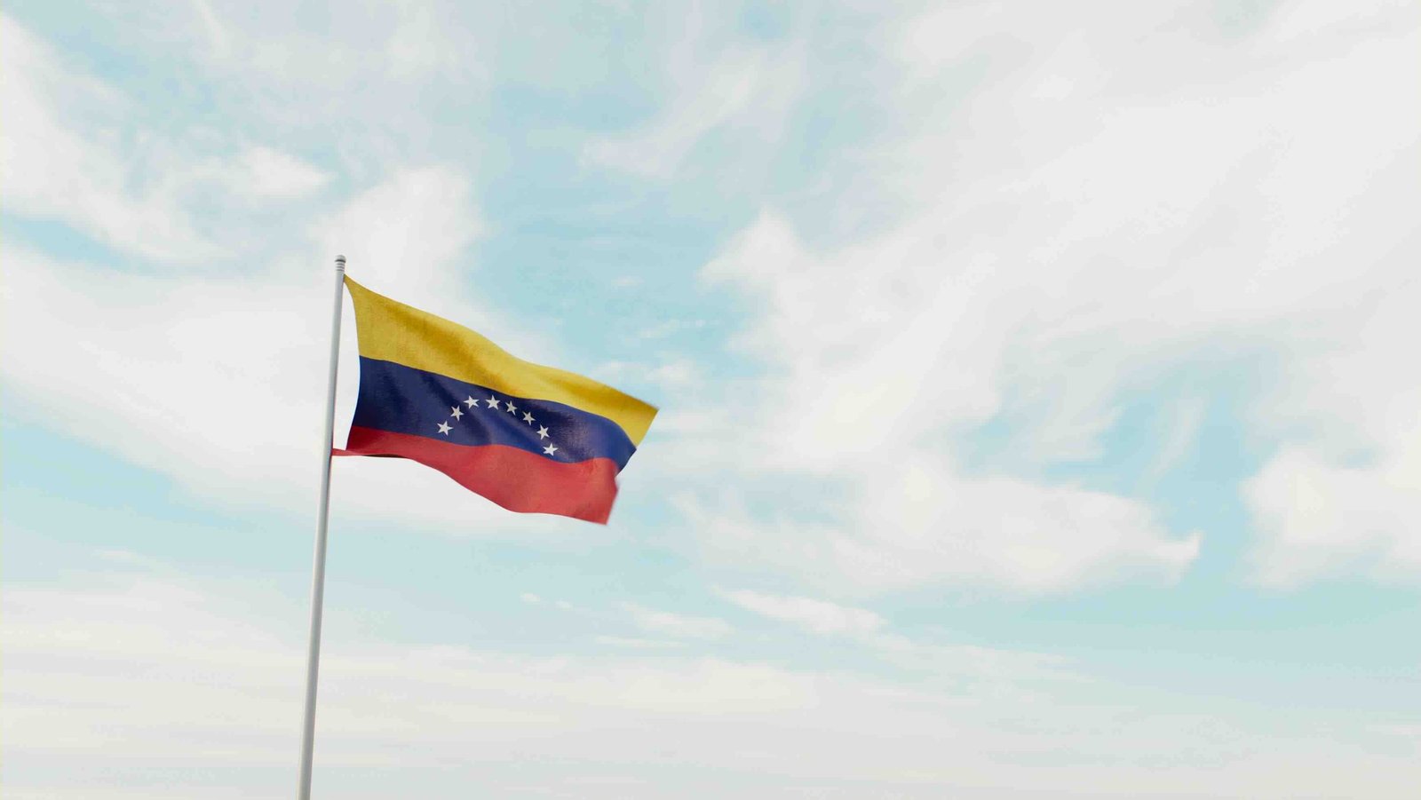 Das Bild zeigt die wehende Flagge des Staates Venezuela.